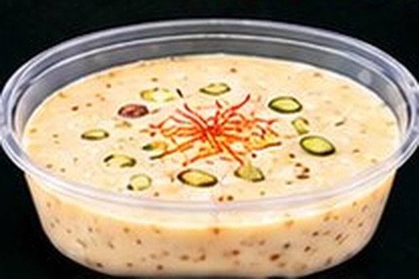 A sweet dish topped with pistachio and saffron