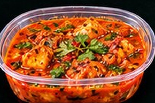 A wet curry in a takeaway tub